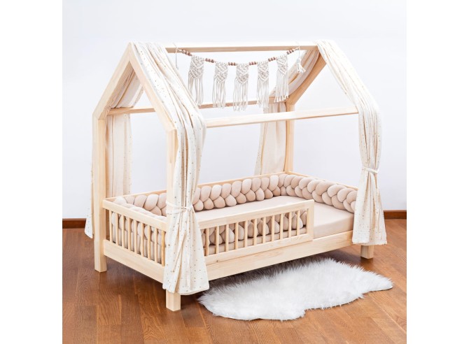 Bed with a beige braided protective bumper